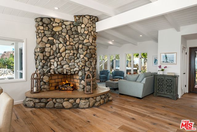 Fireplace, Interior, Living room, Recessed Lighting, Stone Walls, Wood Texture Flooring