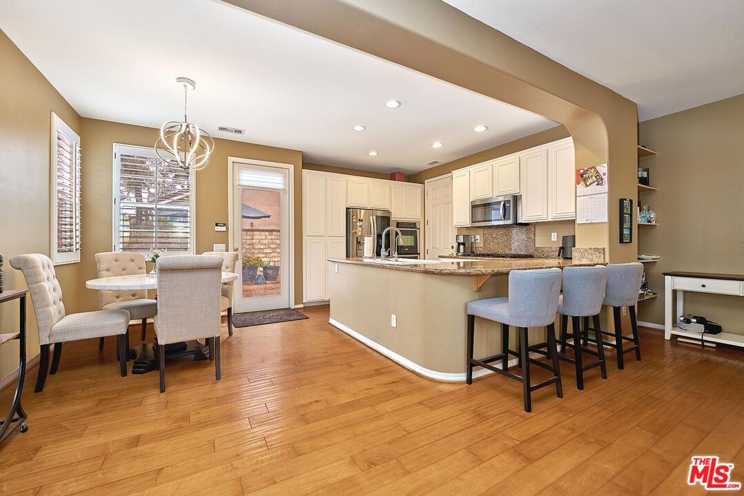 Dining room, Interior, Kitchen, Pendant Lights, Recessed Lighting, Stainless Steel Appliances, Wood Texture Flooring