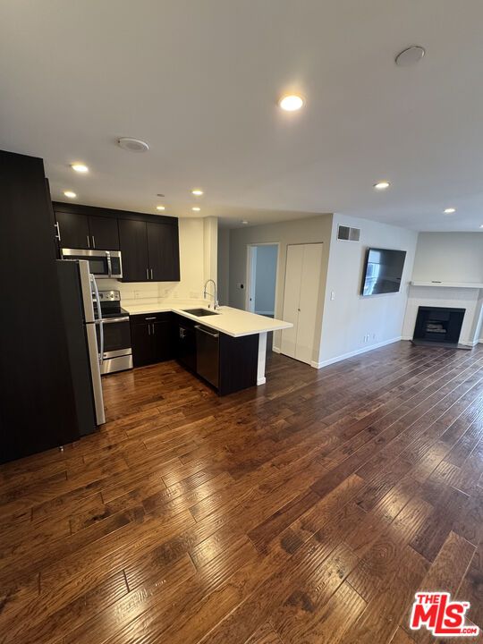 Fireplace, Interior, Kitchen, Recessed Lighting, Stainless Steel Appliances, Wood Texture Flooring