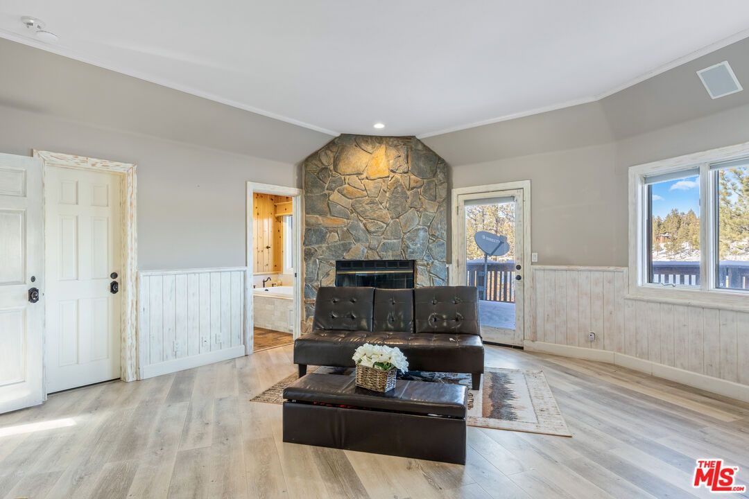 Fireplace, Interior, Living room, Recessed Lighting, Stone Walls, Wood Texture Flooring