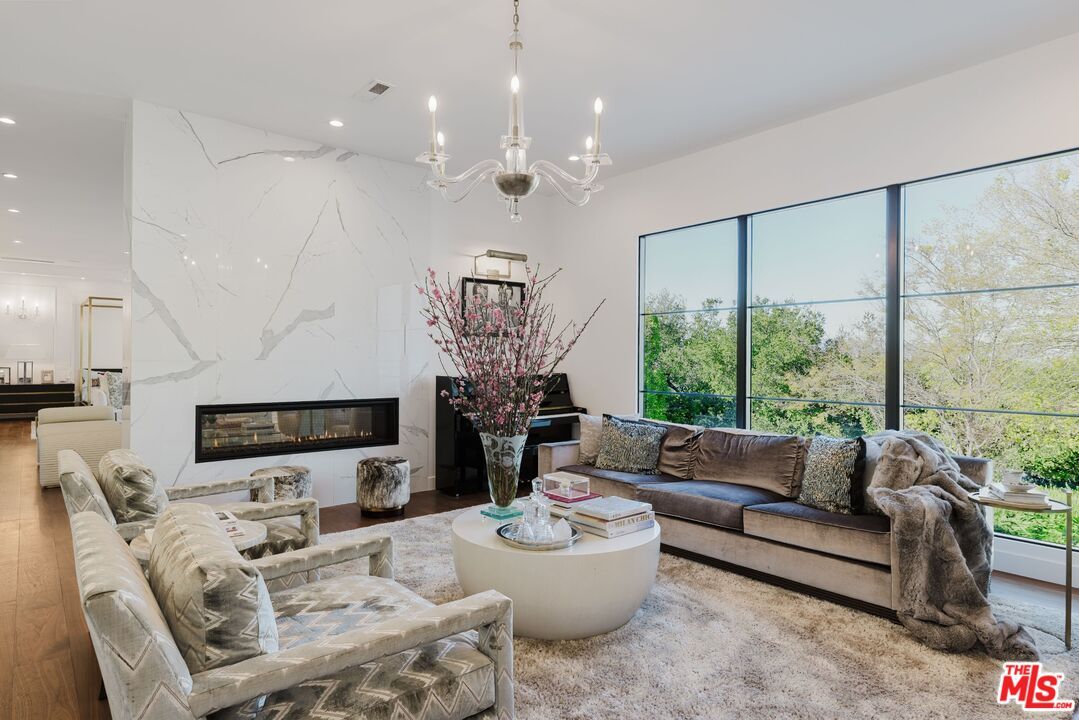 Chandelier, Fireplace, Interior, Living room, Marble Walls, Recessed Lighting, Wood Texture Flooring