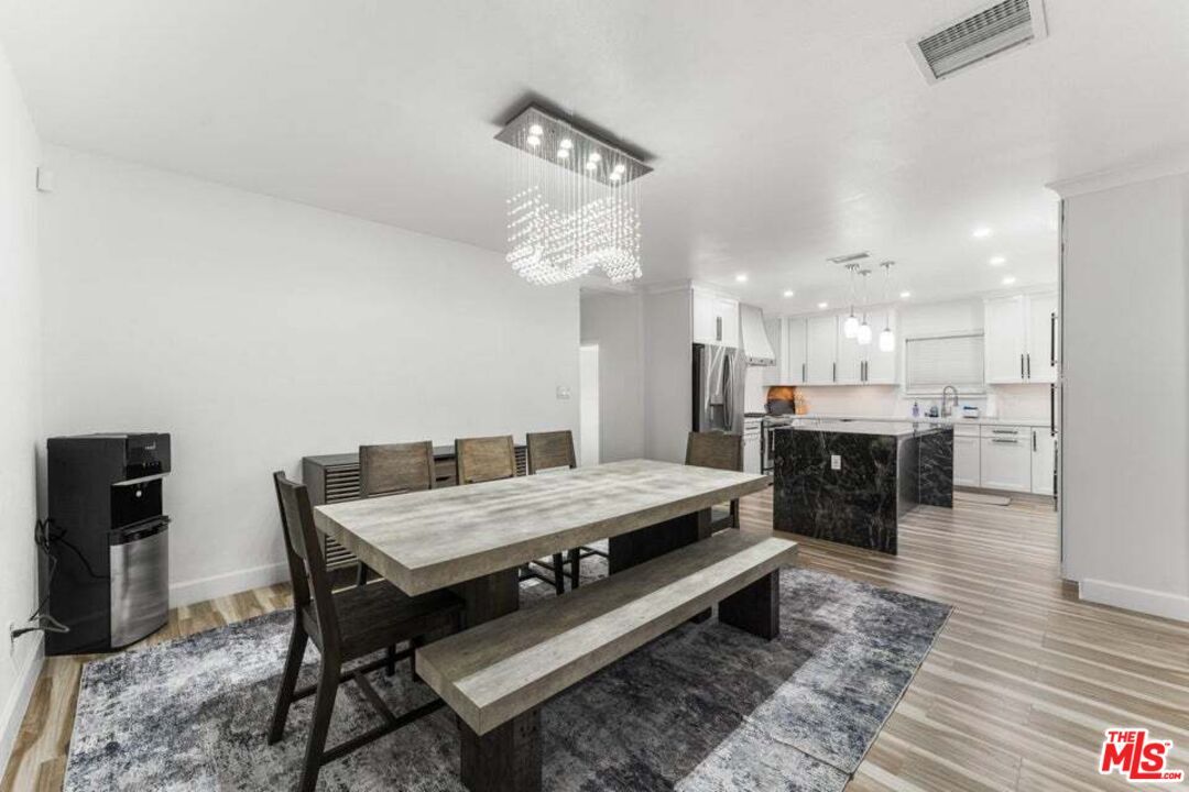 Chandelier, Dining room, Interior, Kitchen, Pendant Lights, Recessed Lighting, Stainless Steel Appliances, Wood Texture Flooring