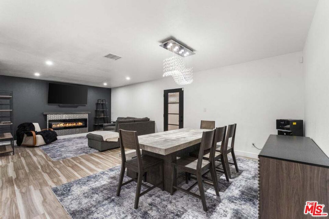 Chandelier, Dining room, Fireplace, Interior, Living room, Pendant Lights, Recessed Lighting, Wood Texture Flooring