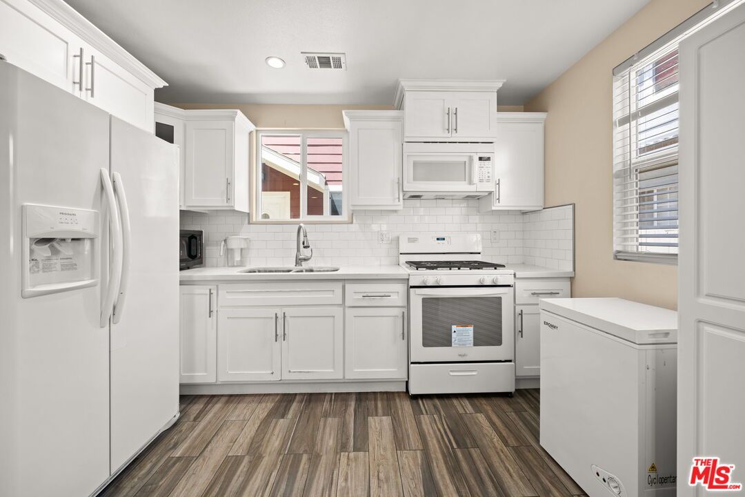Interior, Kitchen, Recessed Lighting, Stainless Steel Appliances, Washer, Wood Texture Flooring