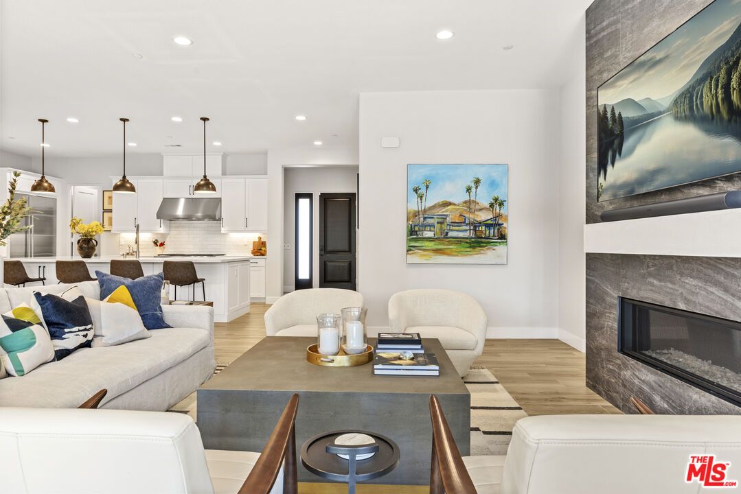 Dining room, Fireplace, Interior, Kitchen, Living room, Pendant Lights, Recessed Lighting, Stainless Steel Appliances, Wood Texture Flooring