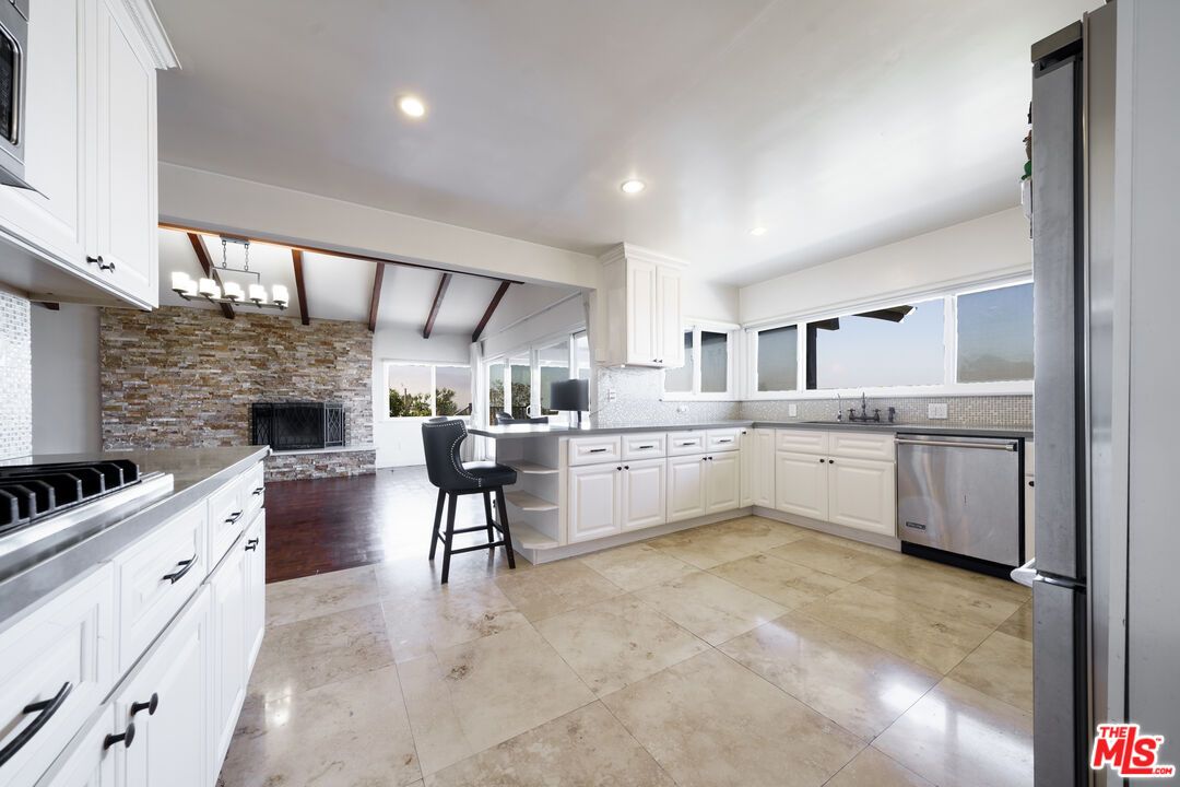 Fireplace, Interior, Kitchen, Recessed Lighting, Stainless Steel Appliances, Stone Walls