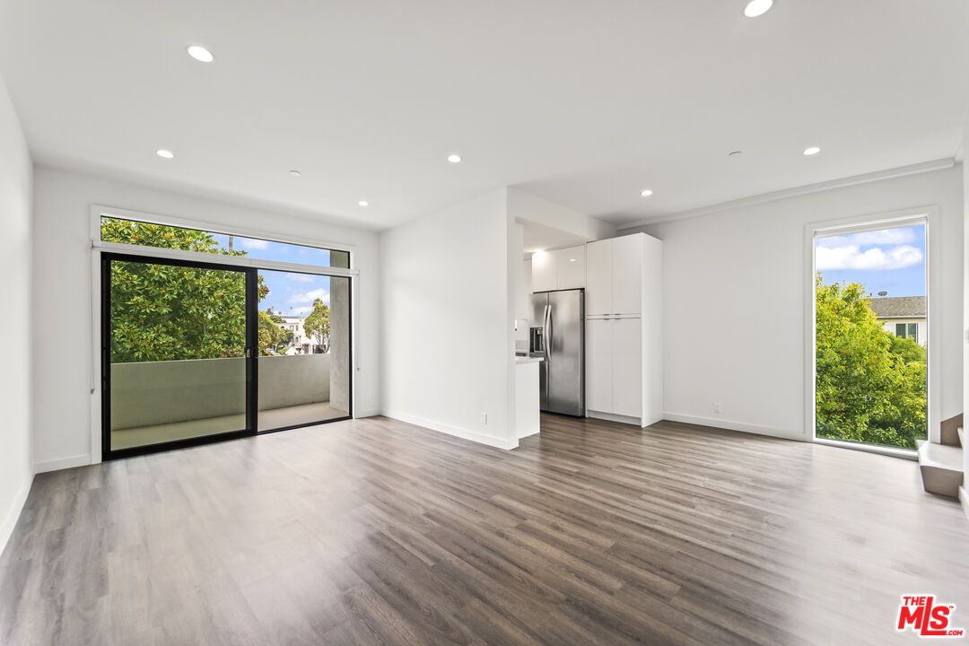 Empty room, Interior, Kitchen, Recessed Lighting, Stainless Steel Appliances, Wood Texture Flooring