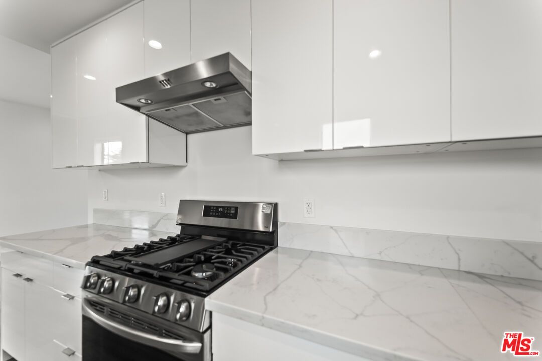 Interior, Kitchen, Marble Walls, Recessed Lighting, Stainless Steel Appliances