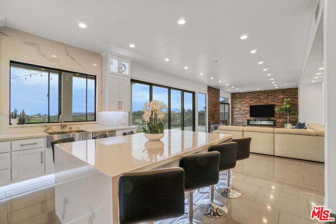 Fireplace, Interior, Kitchen, Living room, Recessed Lighting, Stainless Steel Appliances, Stone Walls