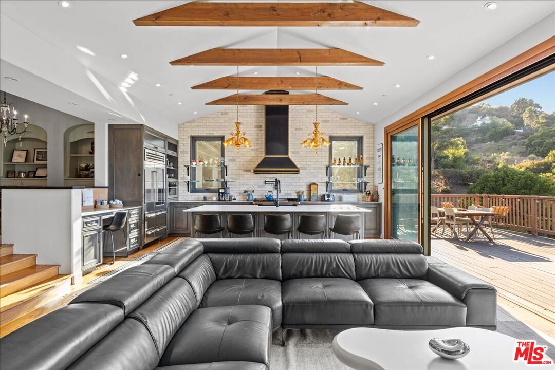 Chandelier, Interior, Kitchen, Living room, Recessed Lighting, Stainless Steel Appliances, Stone Walls, Wooden Beams, Wood Texture Flooring