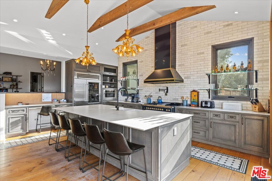 Chandelier, Interior, Kitchen, Pendant Lights, Recessed Lighting, Stainless Steel Appliances, Stone Walls, Wooden Beams, Wood Texture Flooring