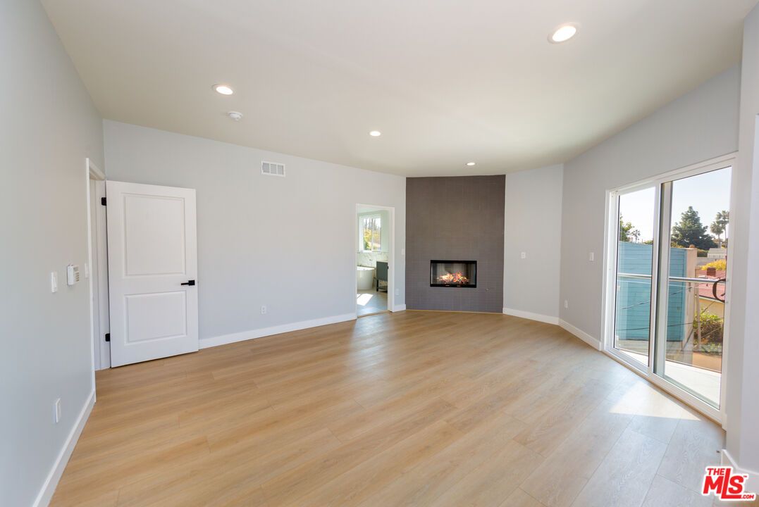 Empty room, Fireplace, Interior, Recessed Lighting, Water, Wood Texture Flooring