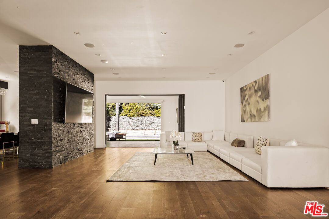Fireplace, Interior, Living room, Recessed Lighting, Stone Walls, Wood Texture Flooring