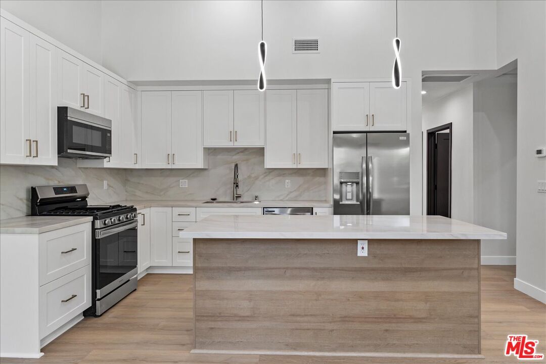 Interior, Kitchen, Marble Walls, Pendant Lights, Stainless Steel Appliances, Wood Texture Flooring