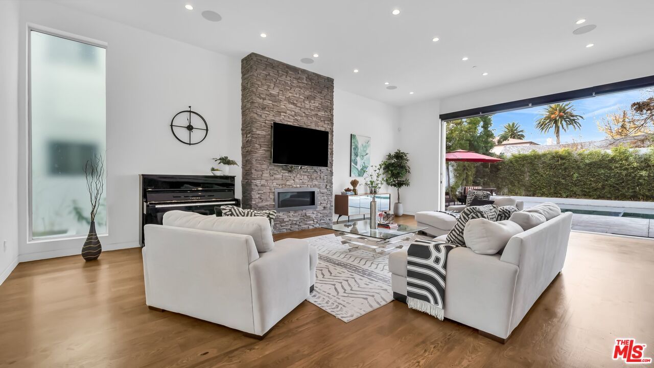 Fireplace, Interior, Living room, Recessed Lighting, Stone Walls, Wood Texture Flooring