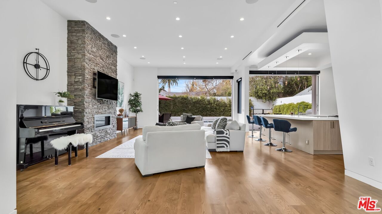 Fireplace, Interior, Living room, Piano, Recessed Lighting, Stone Walls, Wood Texture Flooring