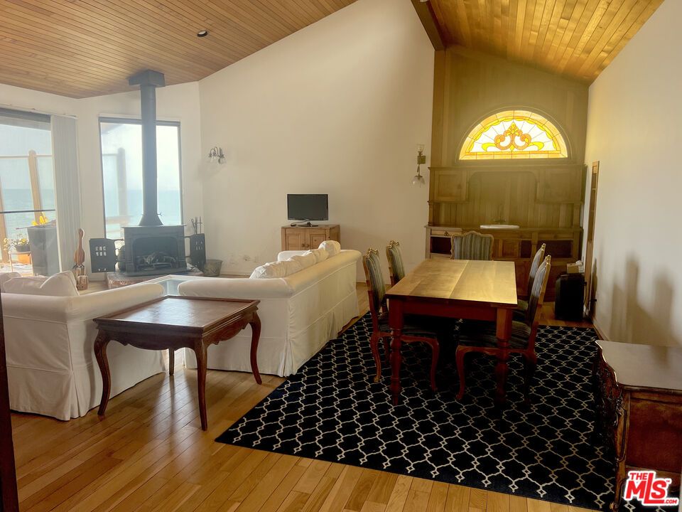 Dining room, Fireplace, Interior, Living room, Water, Wooden Ceilings, Wood Texture Flooring