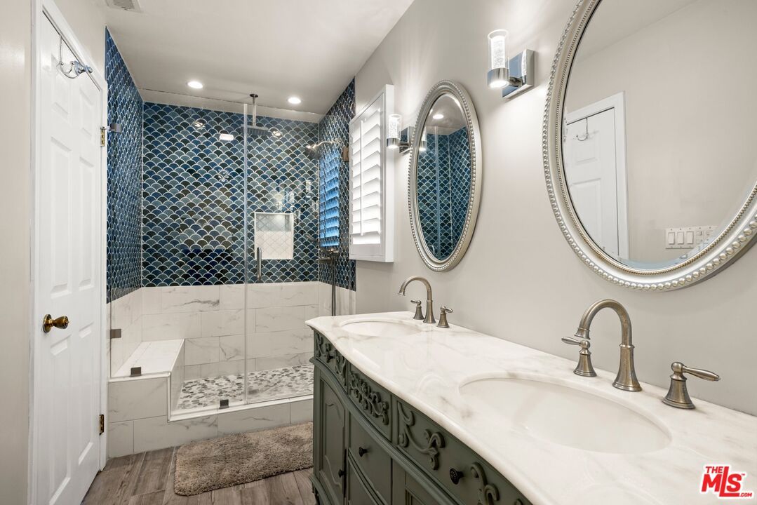 Bathroom, Dual Sink Vanities, Glass Shower, Interior, Marble Walls, Recessed Lighting, Wood Texture Flooring