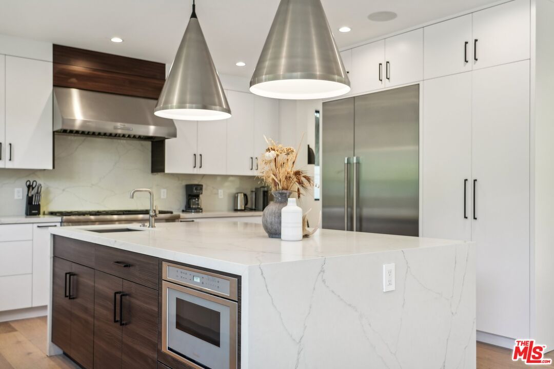 Interior, Kitchen, Marble Walls, Recessed Lighting, Stainless Steel Appliances, Wood Texture Flooring