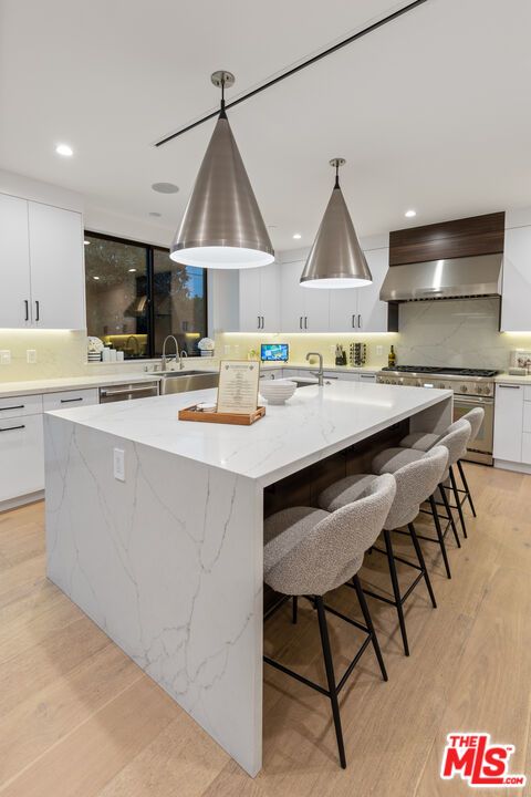 Interior, Kitchen, Marble Walls, Pendant Lights, Recessed Lighting, Stainless Steel Appliances, Wood Texture Flooring