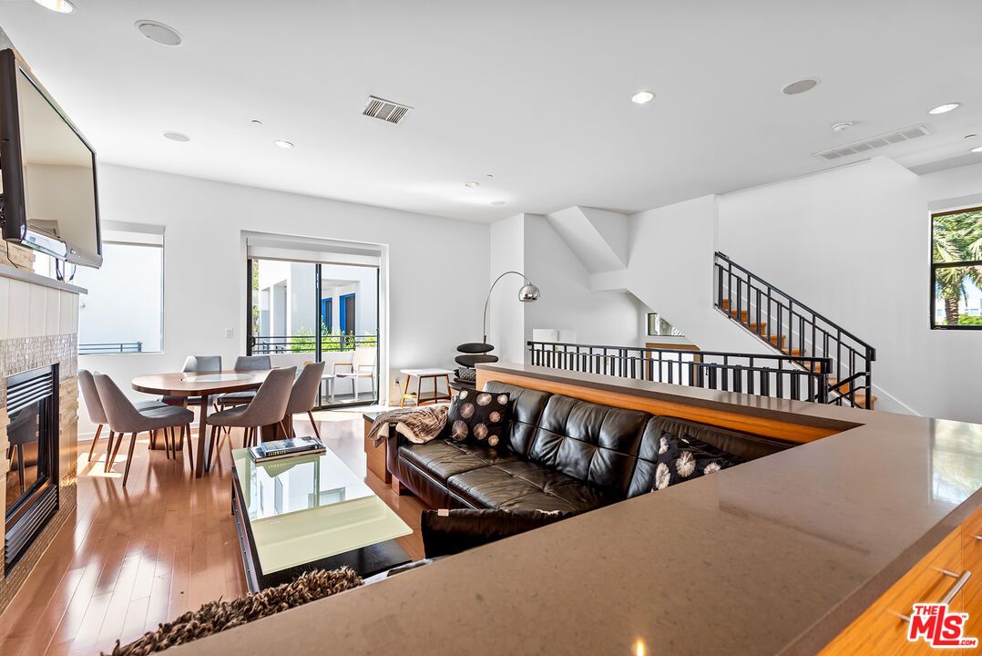 Dining room, Fireplace, Interior, Living room, Recessed Lighting, Wood Texture Flooring