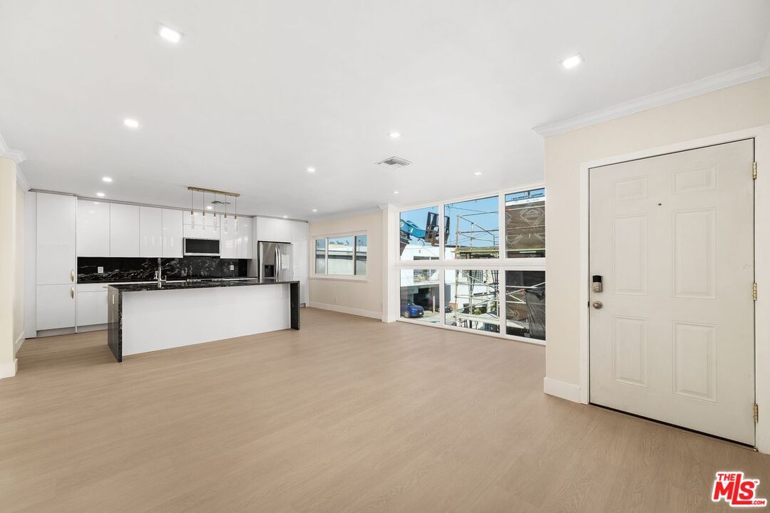 Interior, Kitchen, Marble Walls, Pendant Lights, Recessed Lighting, Stainless Steel Appliances, Wood Texture Flooring