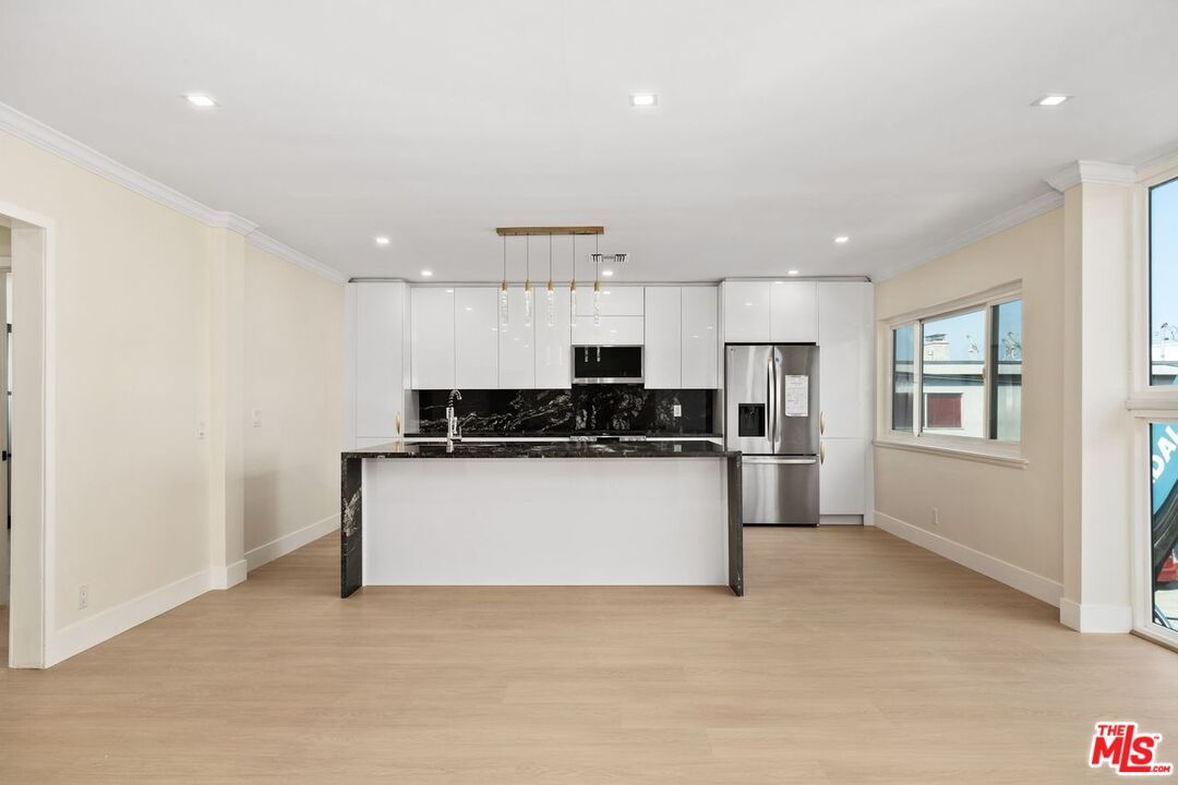 Interior, Kitchen, Marble Walls, Recessed Lighting, Stainless Steel Appliances, Wood Texture Flooring