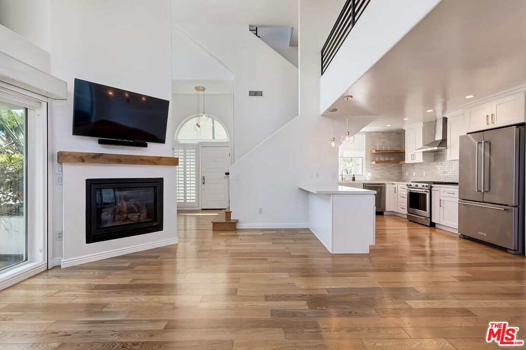 Fireplace, Interior, Kitchen, Pendant Lights, Recessed Lighting, Stainless Steel Appliances, Wood Texture Flooring