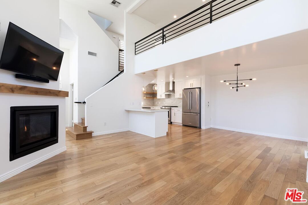 Fireplace, Interior, Kitchen, Pendant Lights, Recessed Lighting, Stainless Steel Appliances, Wood Texture Flooring