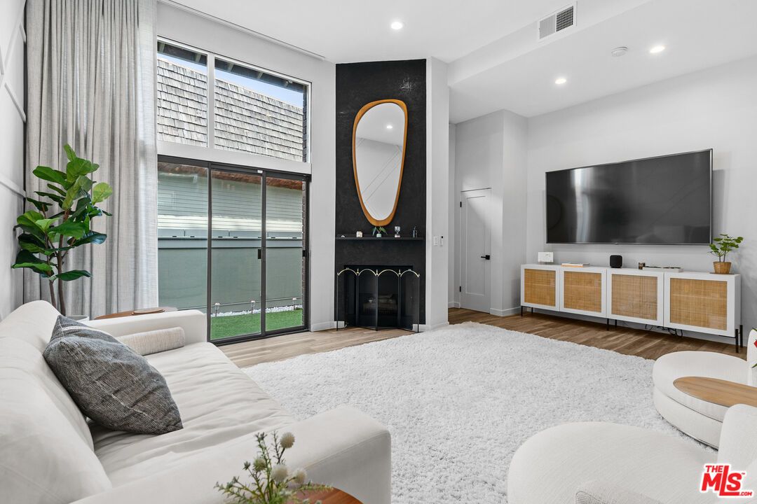 Bedroom, Fireplace, Interior, Living room, Recessed Lighting, Water, Wood Texture Flooring