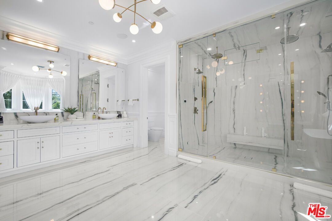 Bathroom, Dual Sink Vanities, Glass Shower, Interior, Marble, Marble Walls, Pendant Lights, Recessed Lighting
