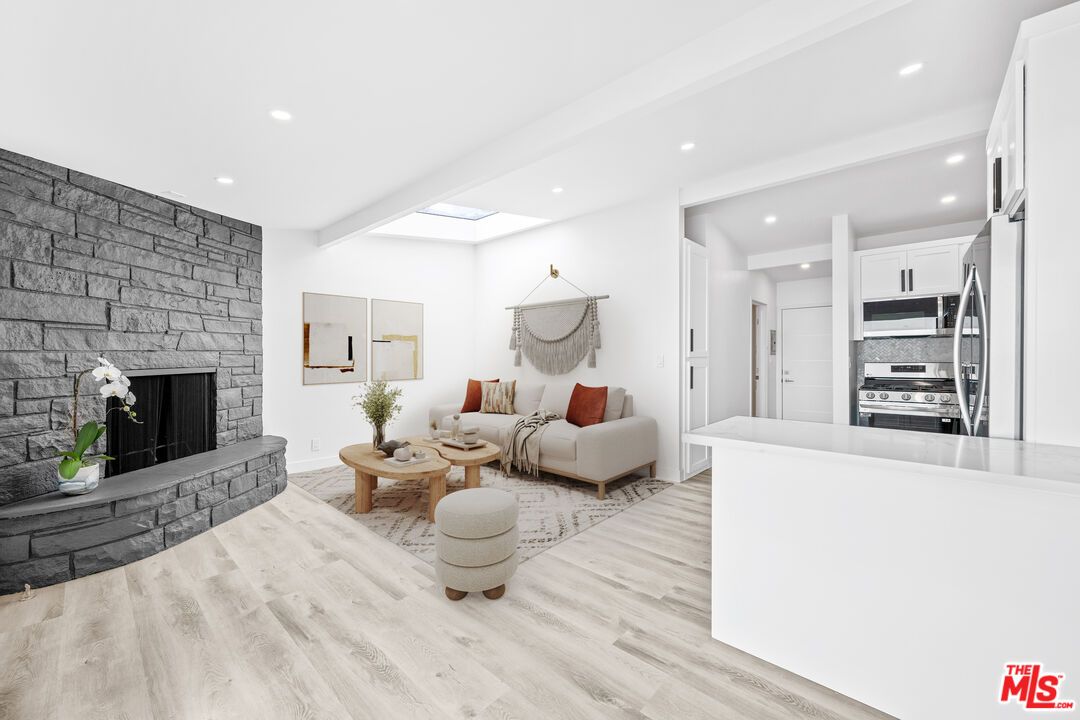 Fireplace, Interior, Kitchen, Living room, Recessed Lighting, Stainless Steel Appliances, Stone Walls, Wood Texture Flooring