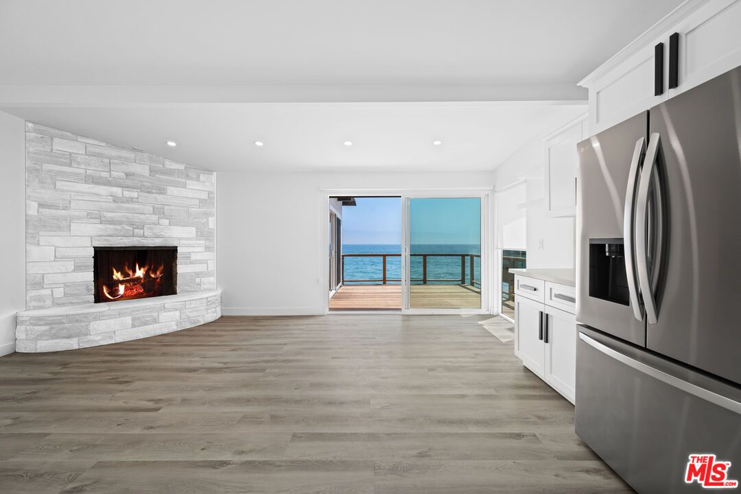 Fireplace, Interior, Kitchen, Recessed Lighting, Stone Walls, Water, Wood Texture Flooring