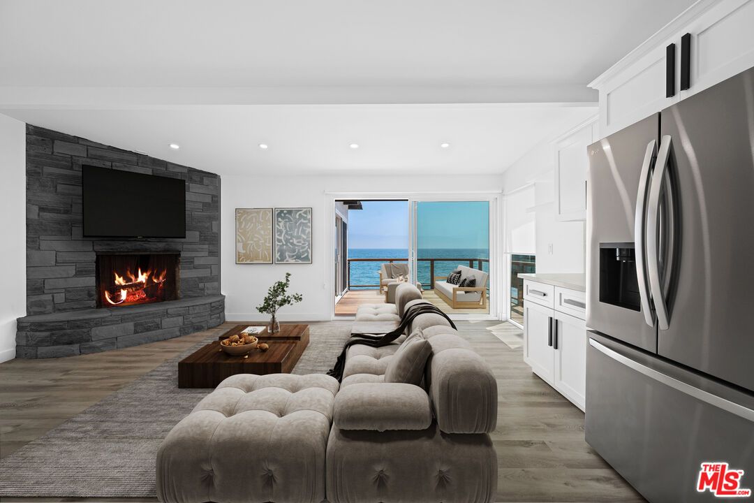 Fireplace, Interior, Kitchen, Living room, Recessed Lighting, Stone Walls, Water, Wood Texture Flooring