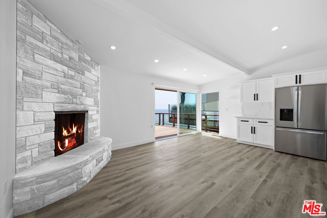 Fireplace, Interior, Kitchen, Recessed Lighting, Stainless Steel Appliances, Stone Walls, Water, Wood Texture Flooring