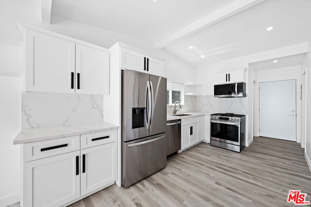 Interior, Kitchen, Marble Walls, Recessed Lighting, Stainless Steel Appliances, Wood Texture Flooring
