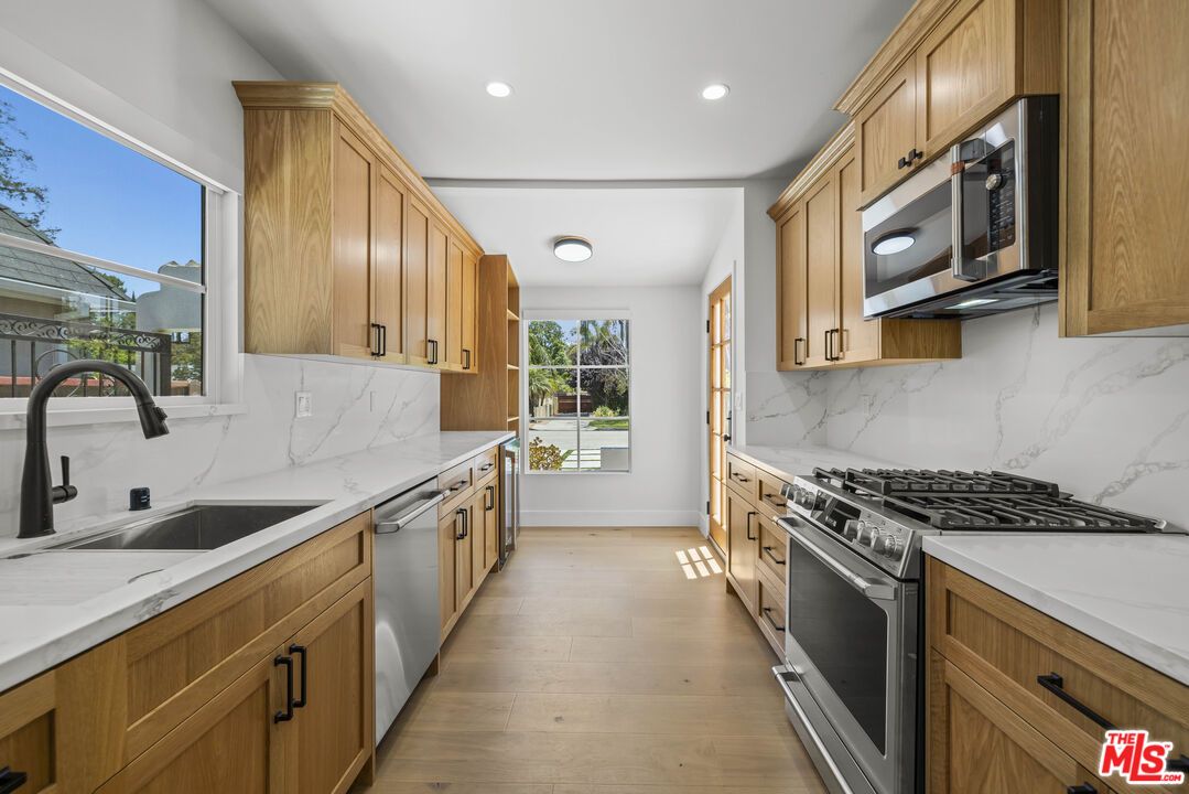 Interior, Kitchen, Marble Walls, Recessed Lighting, Stainless Steel Appliances, Wood Texture Flooring