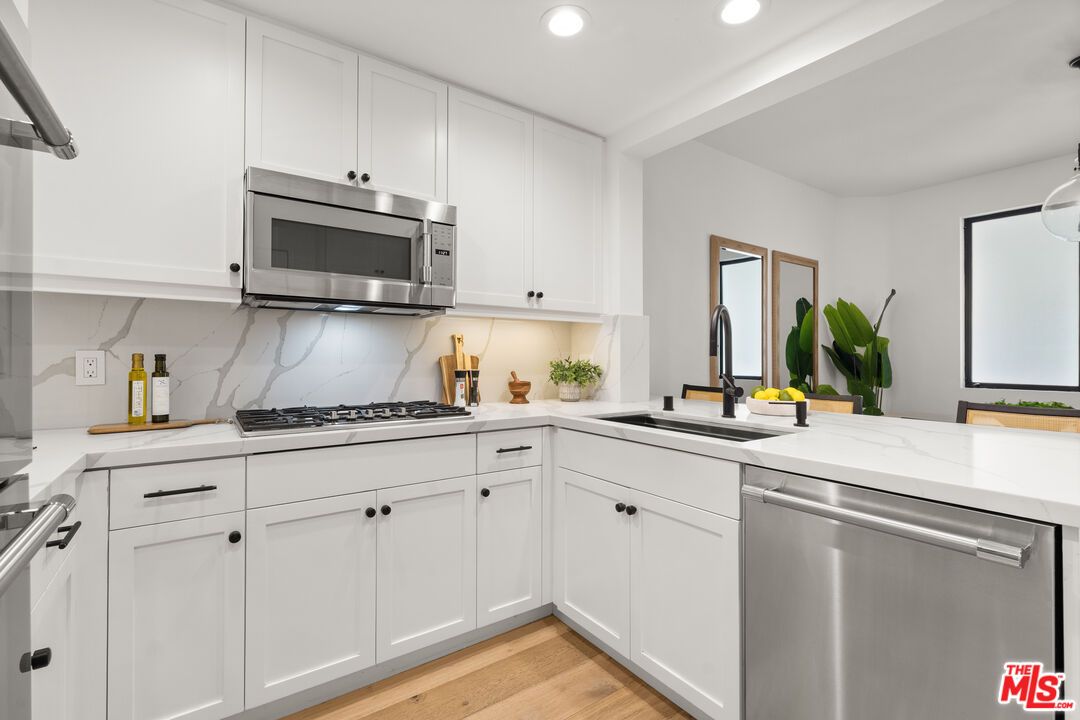 Interior, Kitchen, Marble Walls, Recessed Lighting, Stainless Steel Appliances, Wood Texture Flooring