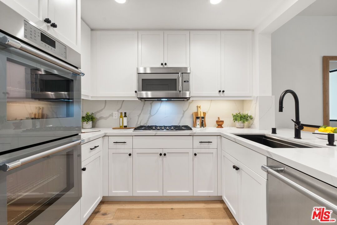 Interior, Kitchen, Marble Walls, Recessed Lighting, Stainless Steel Appliances, Wood Texture Flooring