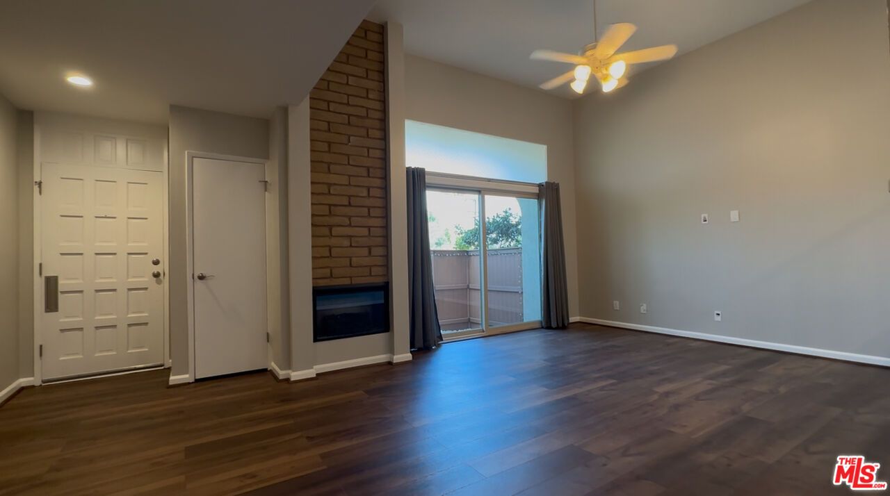 Empty room, Fireplace, Interior, Recessed Lighting, Stone Walls, Wood Texture Flooring