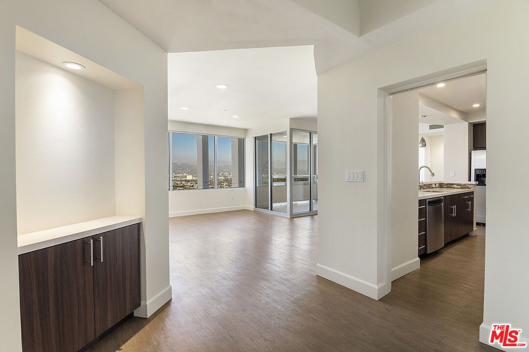 Empty room, Interior, Kitchen, Recessed Lighting, Stainless Steel Appliances, Wood Texture Flooring