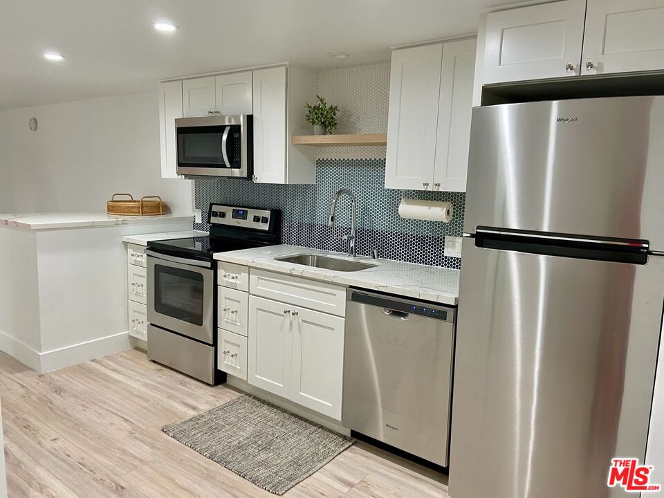 Interior, Kitchen, Recessed Lighting, Stainless Steel Appliances, Tile Countertops, Wood Texture Flooring