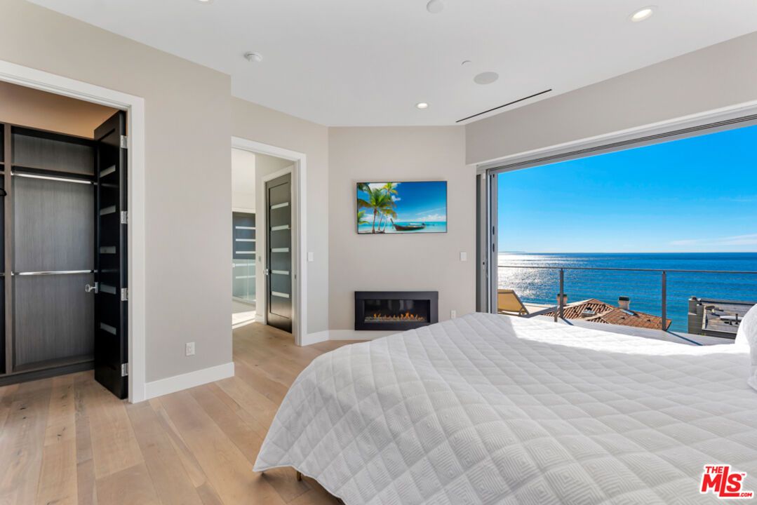 Bedroom, Fireplace, Interior, Recessed Lighting, Water, Wood Texture Flooring