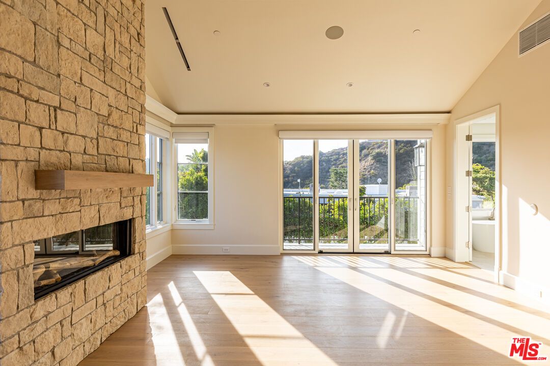 Empty room, Fireplace, Interior, Recessed Lighting, Stone Walls, Wood Texture Flooring