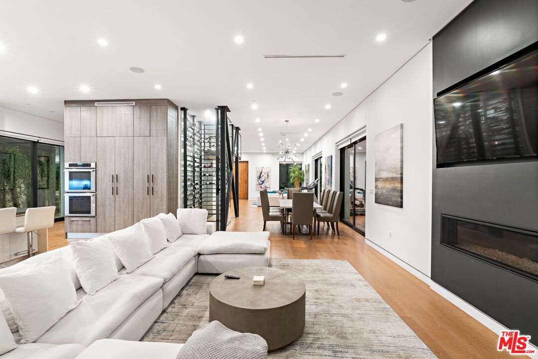Dining room, Fireplace, Interior, Kitchen, Living room, Pendant Lights, Recessed Lighting, Stainless Steel Appliances, Wood Texture Flooring