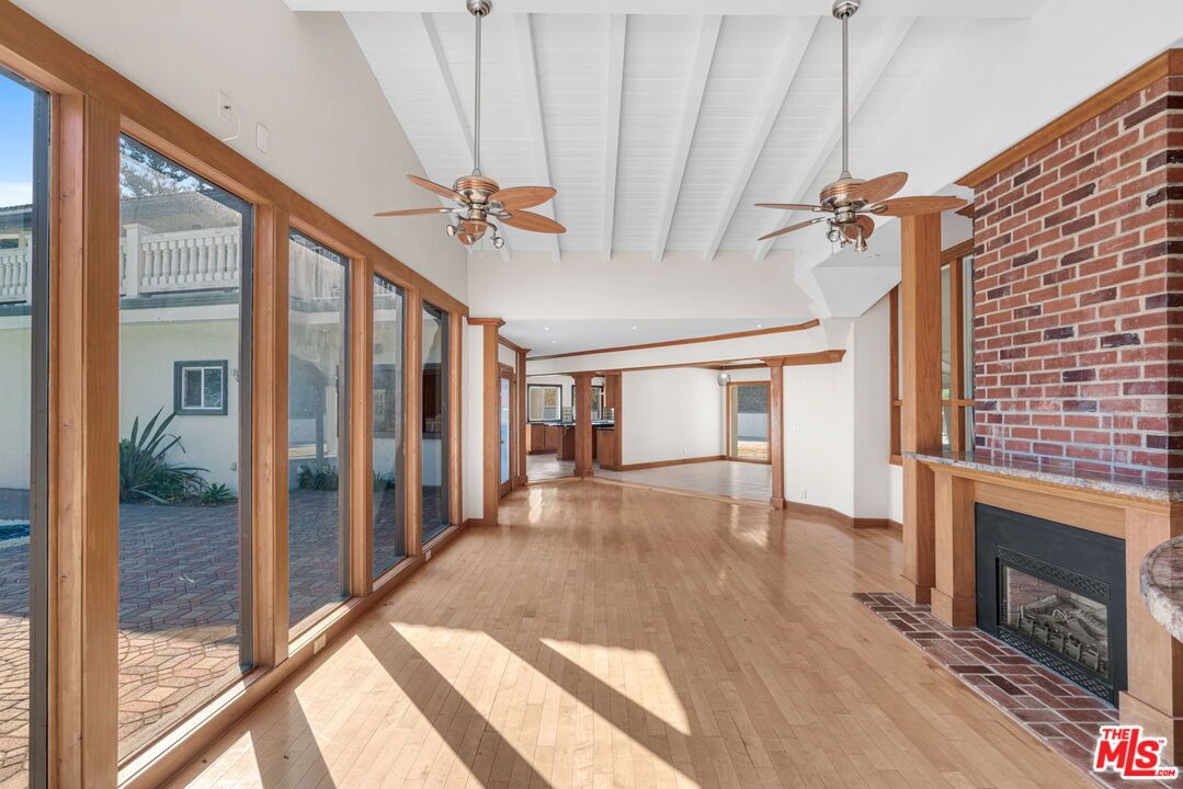 Empty room, Fireplace, Interior, Recessed Lighting, Stone Walls, Wood Texture Flooring