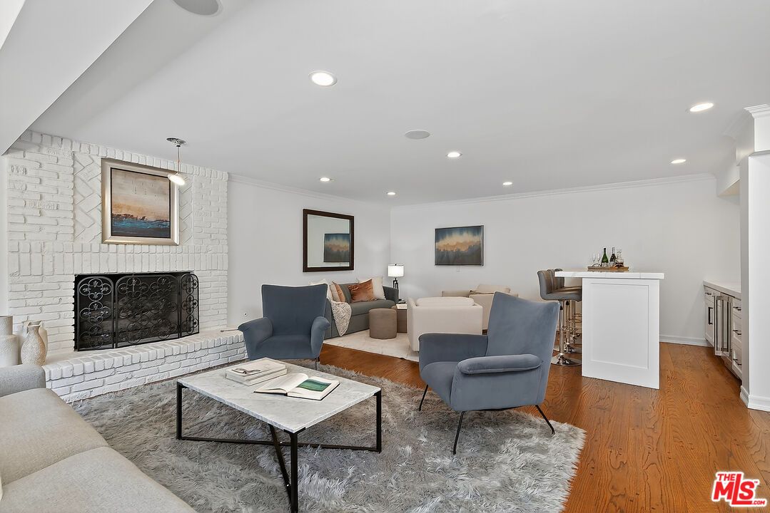 Fireplace, Interior, Living room, Recessed Lighting, Stone Walls, Wood Texture Flooring