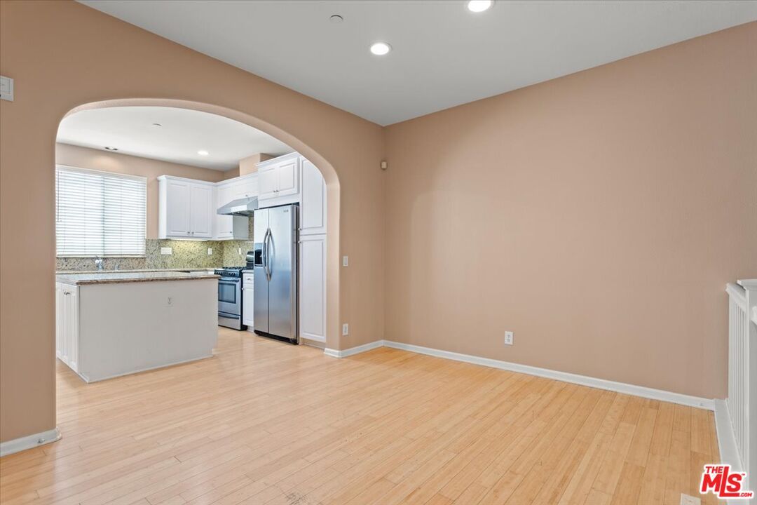 Empty room, Interior, Kitchen, Recessed Lighting, Stainless Steel Appliances, Wood Texture Flooring