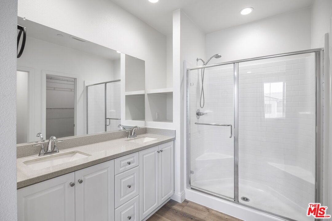 Bathroom, Dual Sink Vanities, Glass Shower, Interior, Recessed Lighting, Wood Texture Flooring