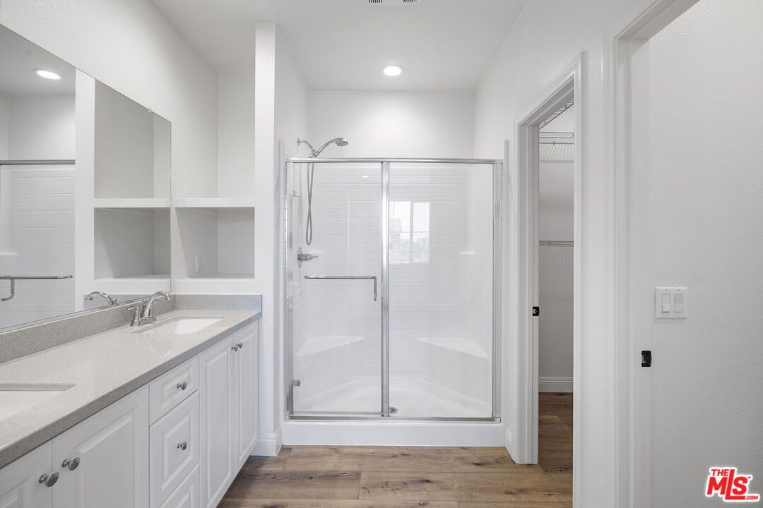 Bathroom, Dual Sink Vanities, Glass Shower, Interior, Recessed Lighting, Wood Texture Flooring